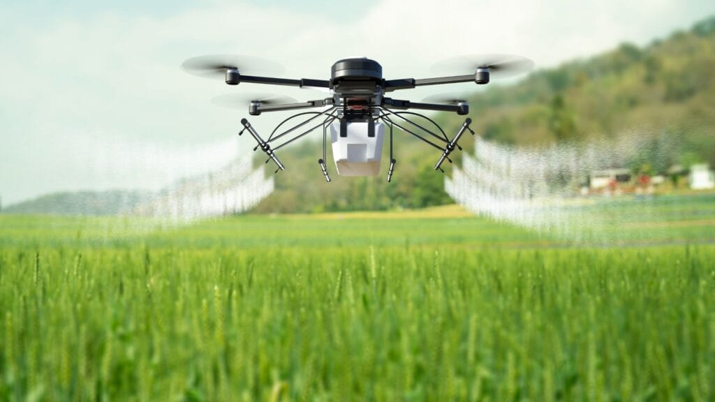 Drone spraying pesticides over crops